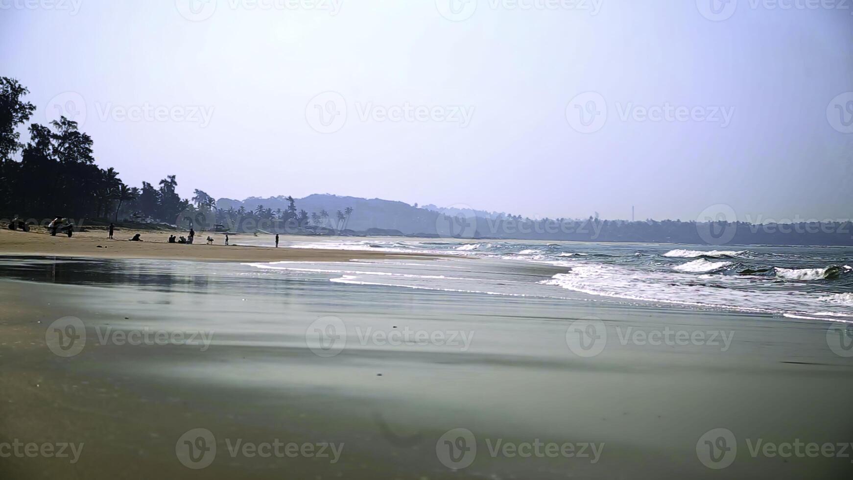 A Beautiful and Serene Beach View Featuring Gentle Waves and a Lush, Vibrant Background. Stock Clip photo