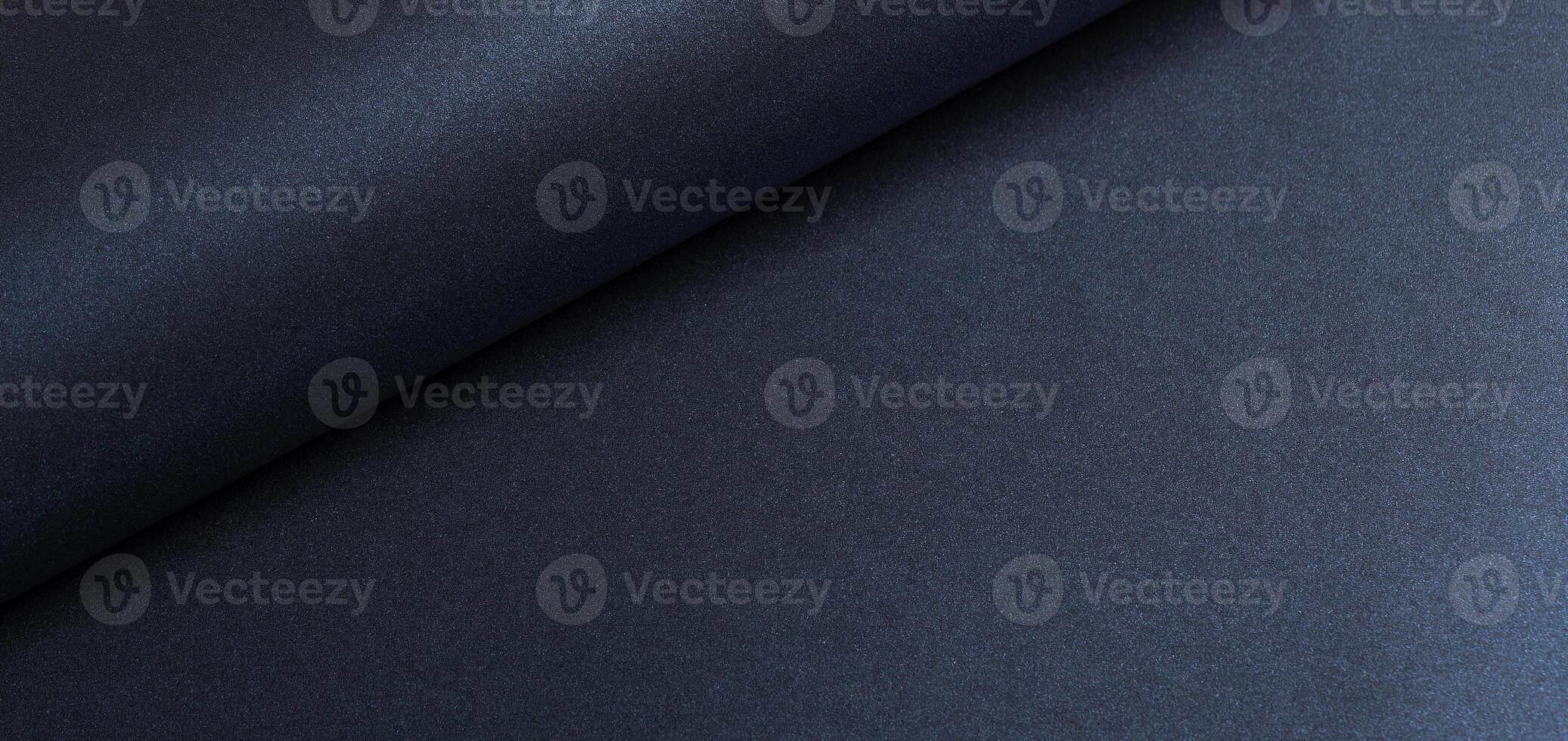 Dark blue rolled paper background with a smooth, shiny texture. Elegant and minimalist design photo