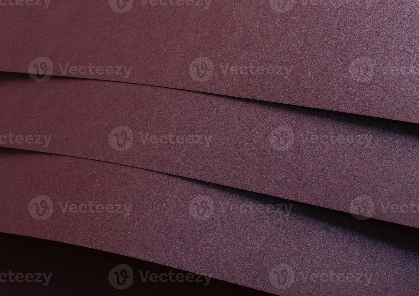 Metallic burgundy paper background with smooth, shimmering lines and a reflective surface. Featuring photo