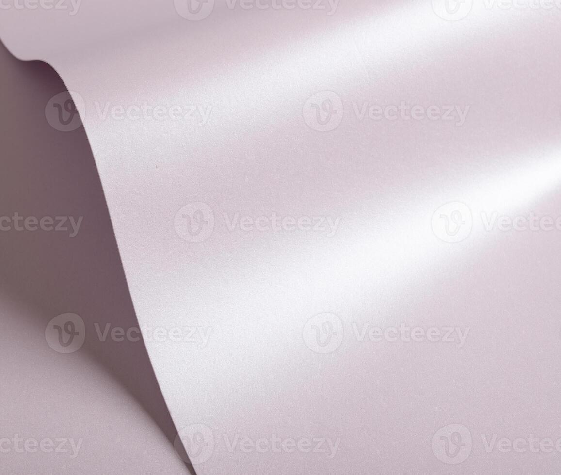Light pastel paper background with a smooth satin texture and gentle curves. Featuring a luminous photo