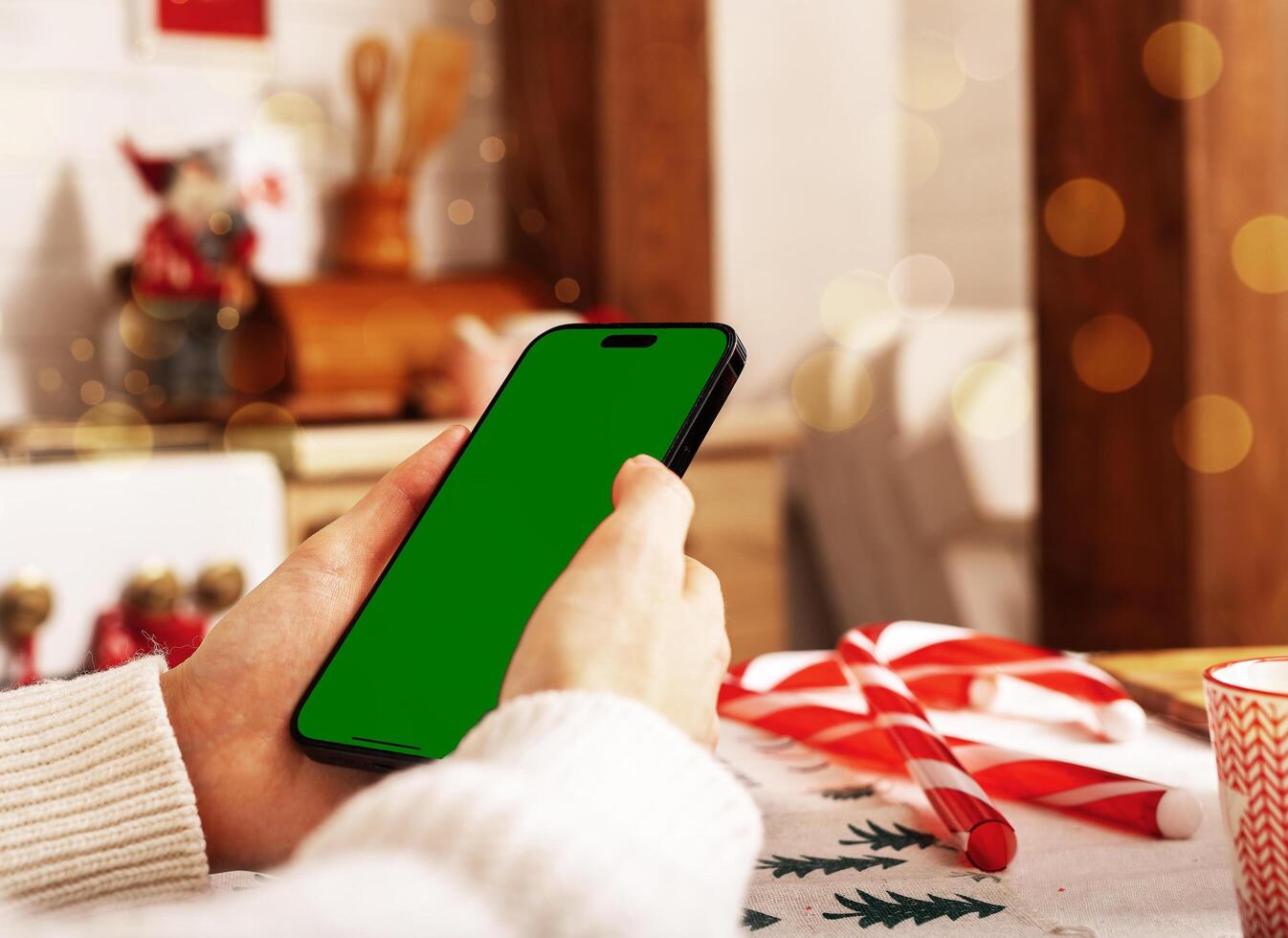 Lodz Poland July 20 2024 Hand holding mobile phone mockup, iphone screen mock up, Christmas holiday photo