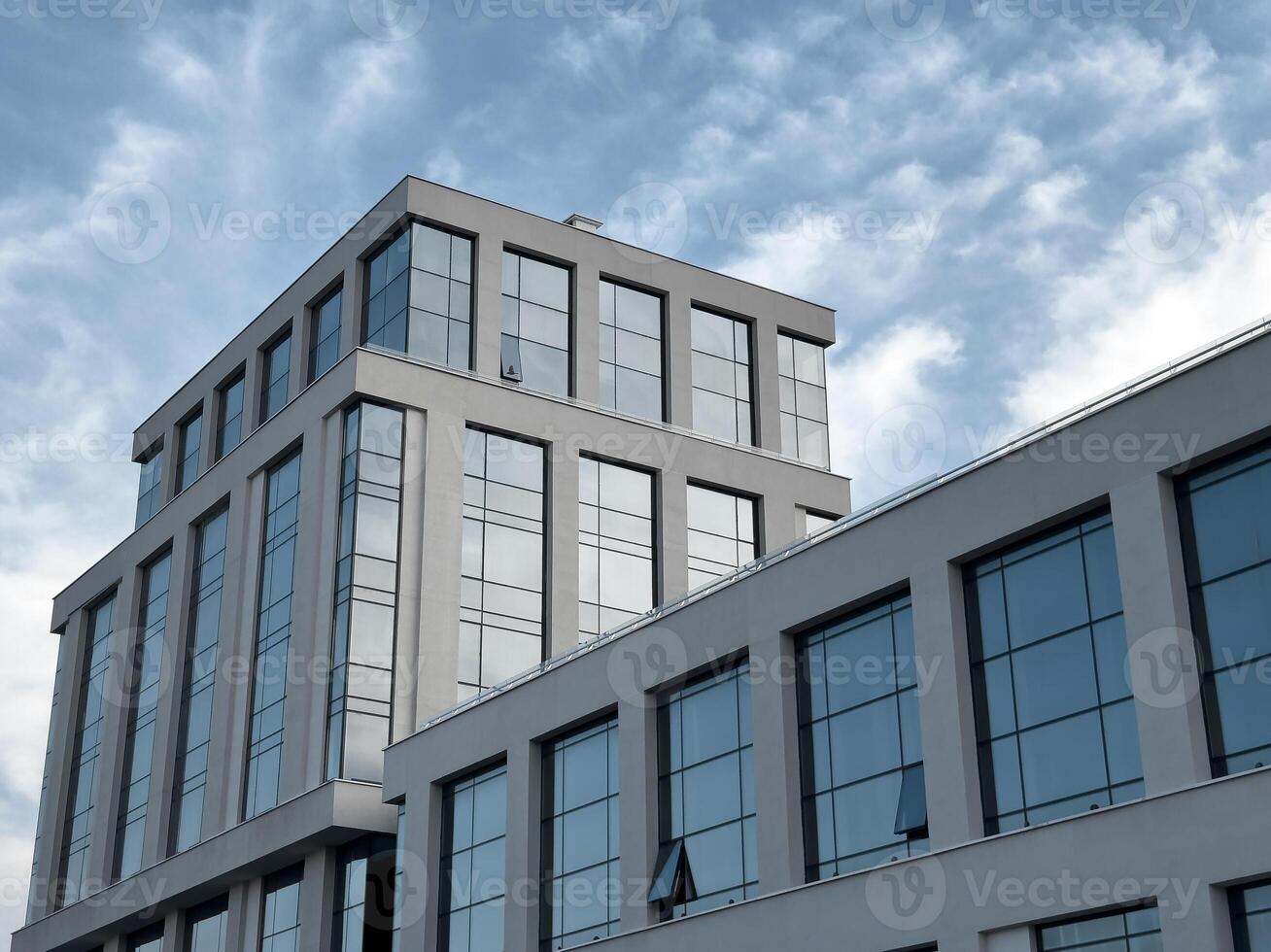 Modern office building in a corporate cityscape. Commercial structure exterior, sky. Smart photo