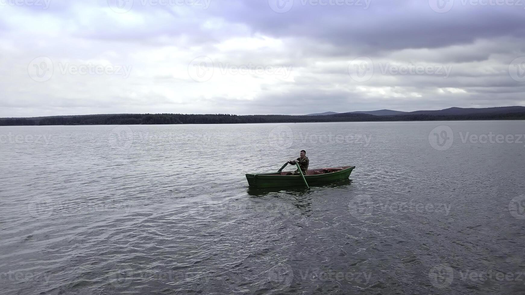 Enjoy the peaceful activity of kayaking on a serene lake, surrounded by natures tranquility. Stock Clip photo