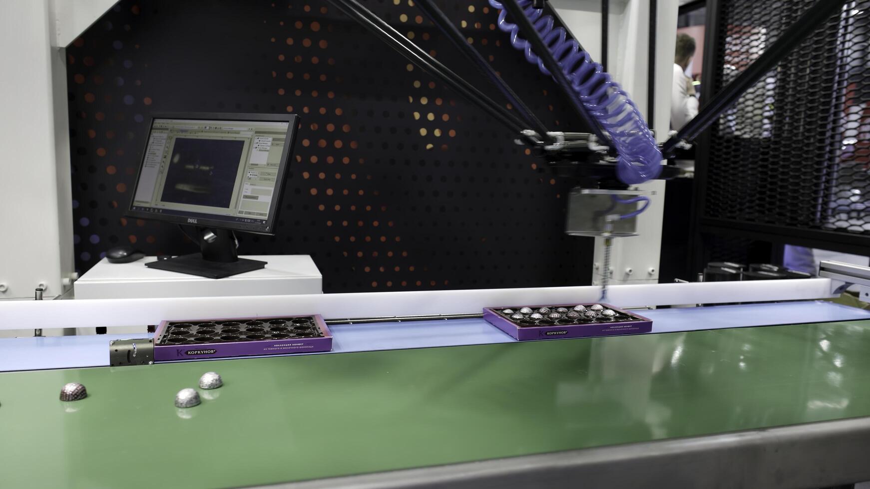 Dubai, UAE - June 2024. An Automated Assembly Line with a Robotic Arm and Control Screen for operation management. Media photo
