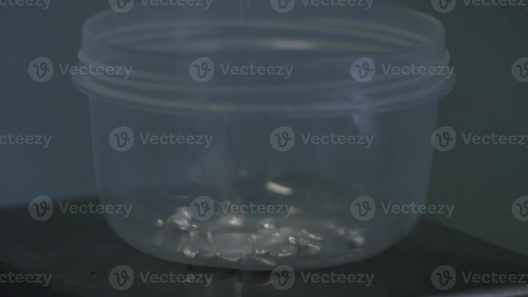 A clear plastic container on a table, sturdy and versatile for storage photo