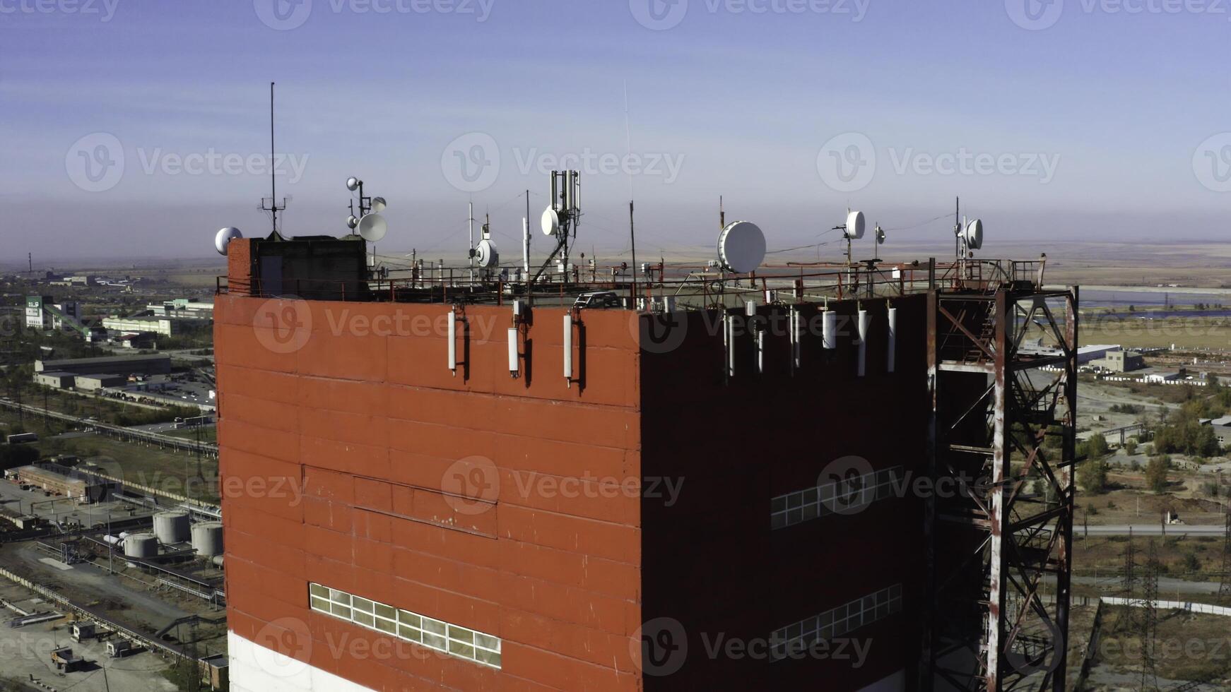 A Stunning Aerial View Capturing a Bright Red Communication Tower Set Against a Clear Blue Sky. Stock Clip photo