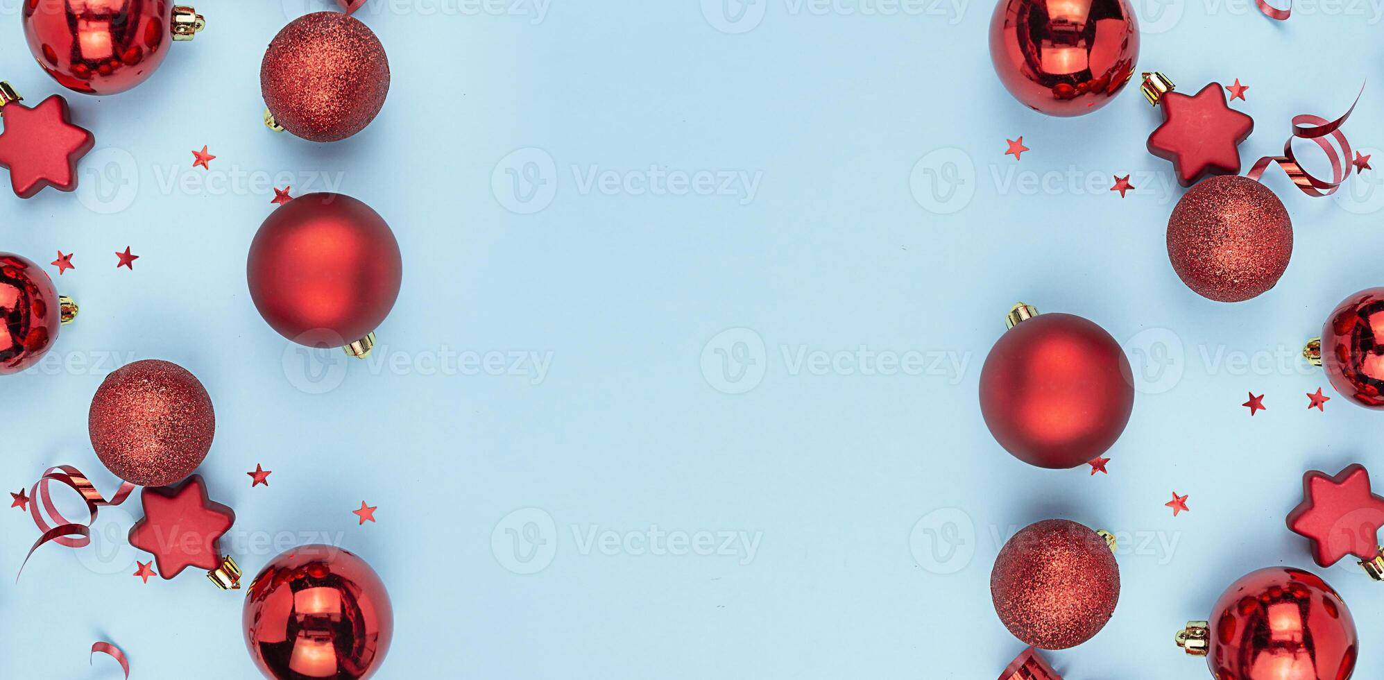 Frame from Christmas red balls on a blue background. Christmas background. New Year's banner. Copy space. photo