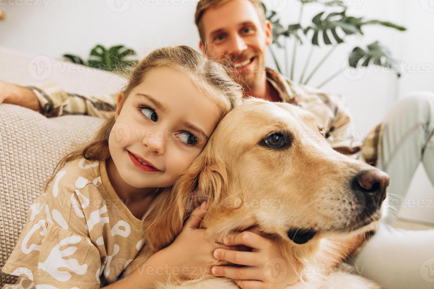 Portrait of cheerful, beautiful little girl hugging golden retriever, selective focus, closeup photo