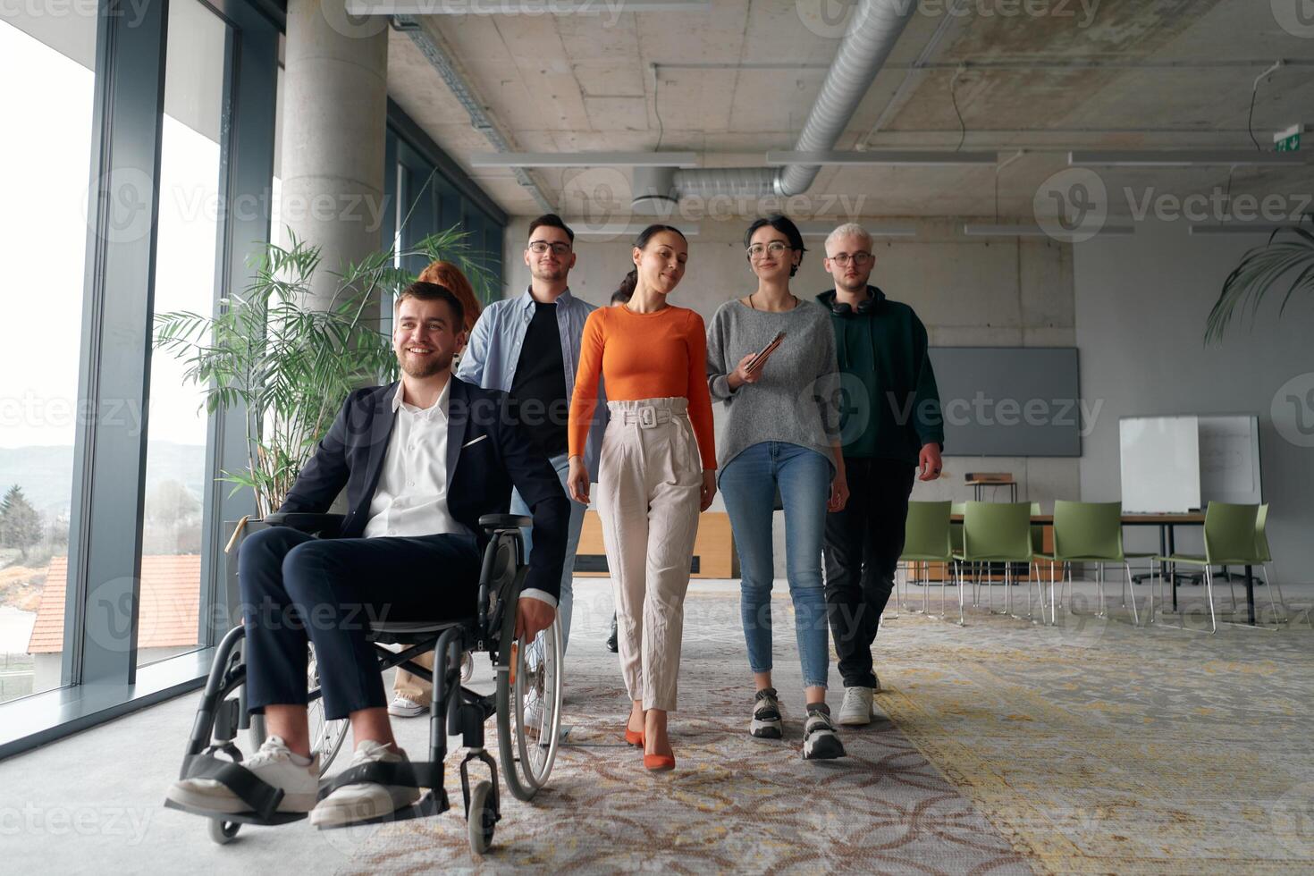 A diverse group of business professionals walking together through the office, symbolizing unity and strength as a collaborative and successful team photo