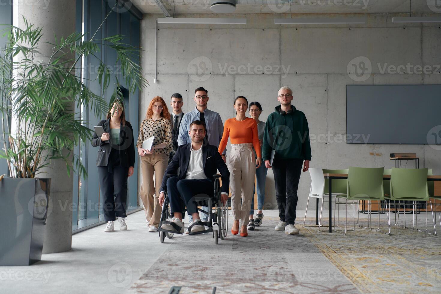 A diverse group of business professionals walking together through the office, symbolizing unity and strength as a collaborative and successful team photo