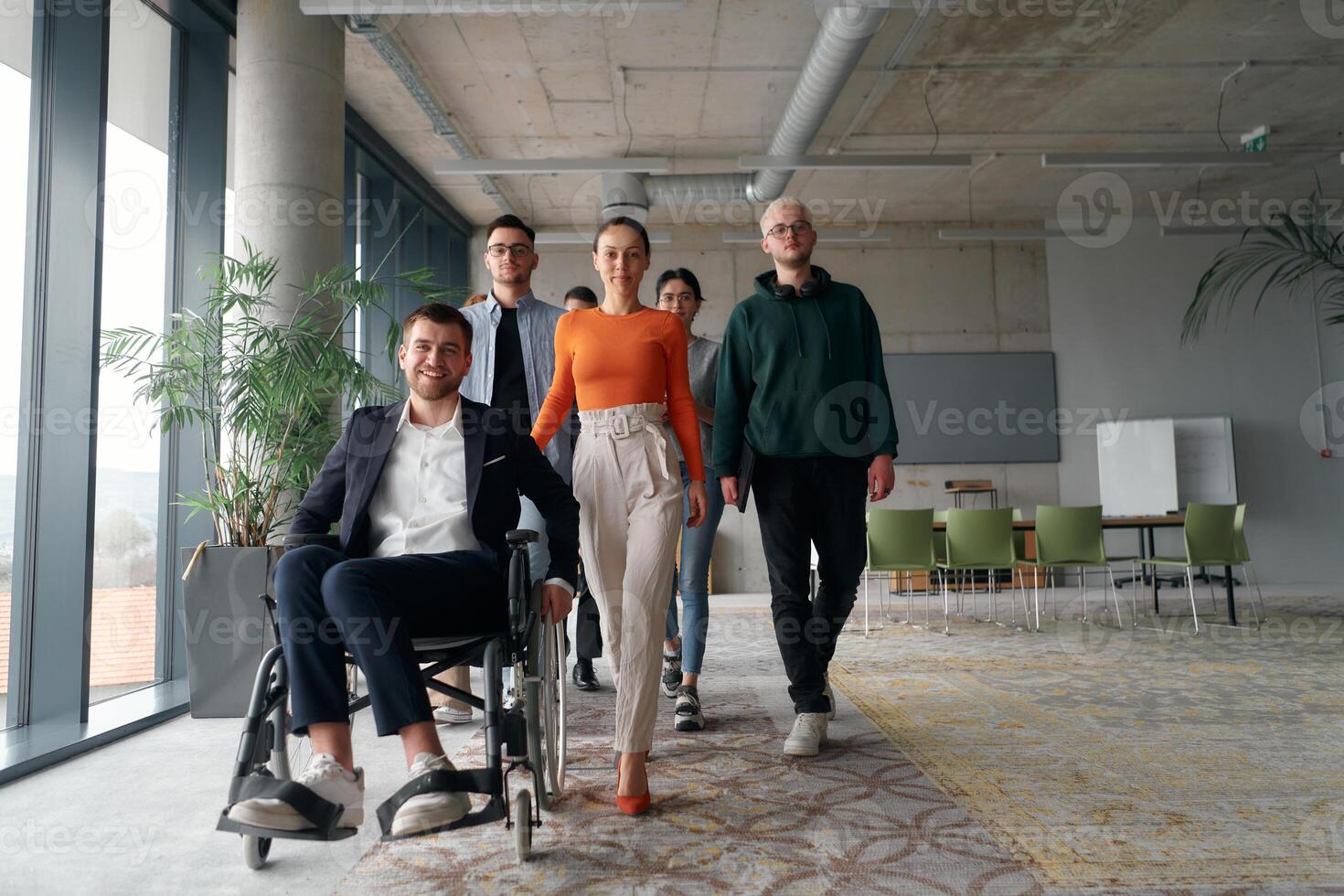 A diverse group of business professionals walking together through the office, symbolizing unity and strength as a collaborative and successful team photo