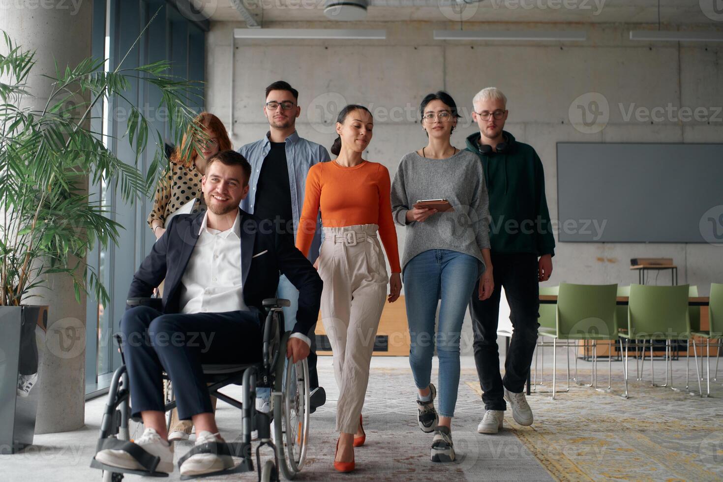 A diverse group of business professionals walking together through the office, symbolizing unity and strength as a collaborative and successful team photo
