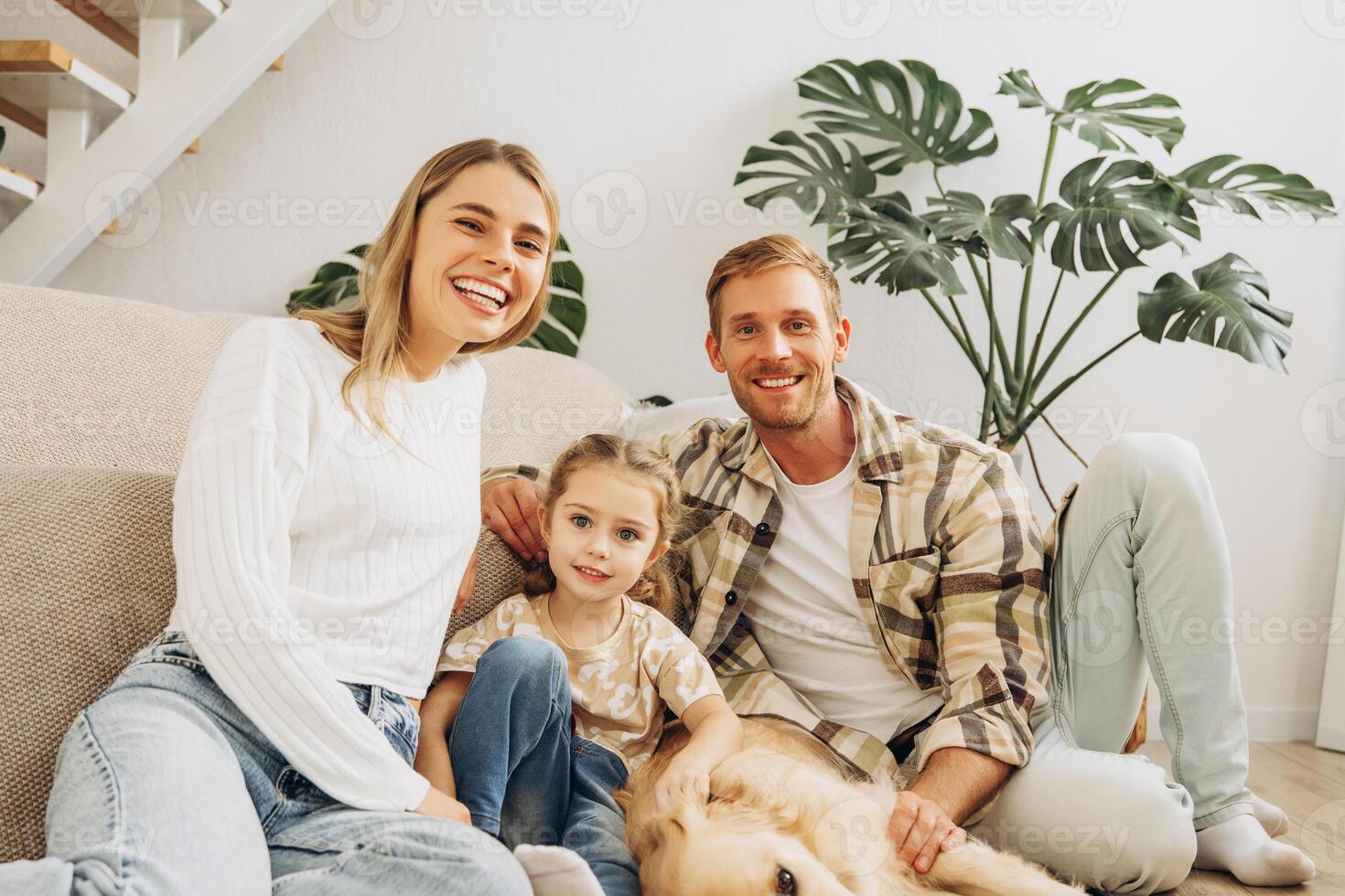 Happy, smiling family, attractive mother, father, little daughter and golden retriever together photo