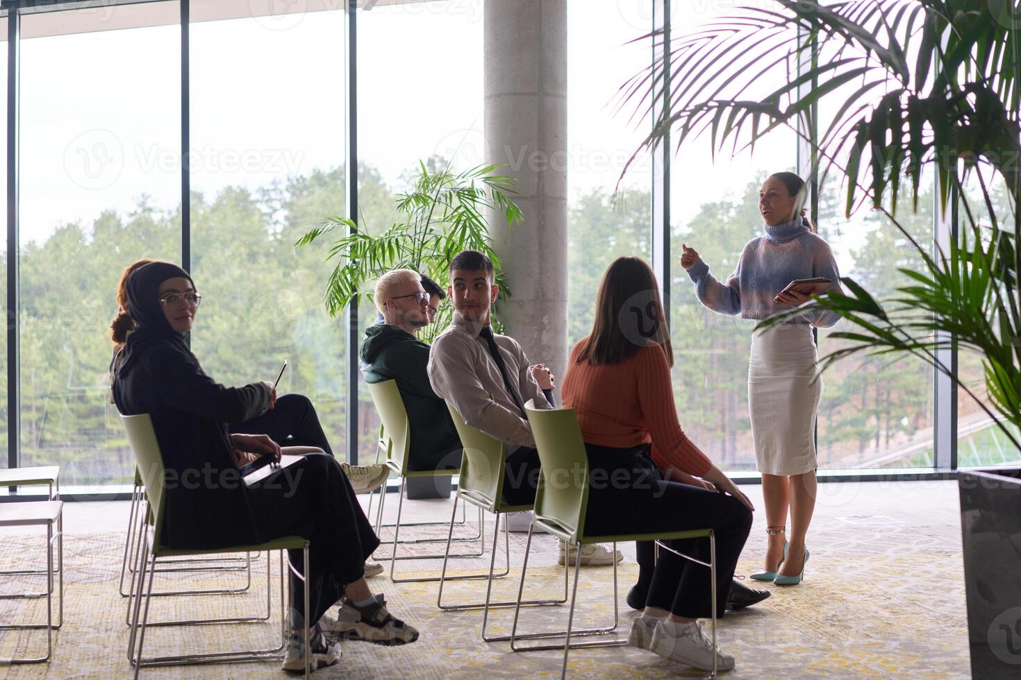 A businesswoman leader guiding a meeting with her colleagues, discussing business challenges, marketing strategies, and new plans for growth and success photo