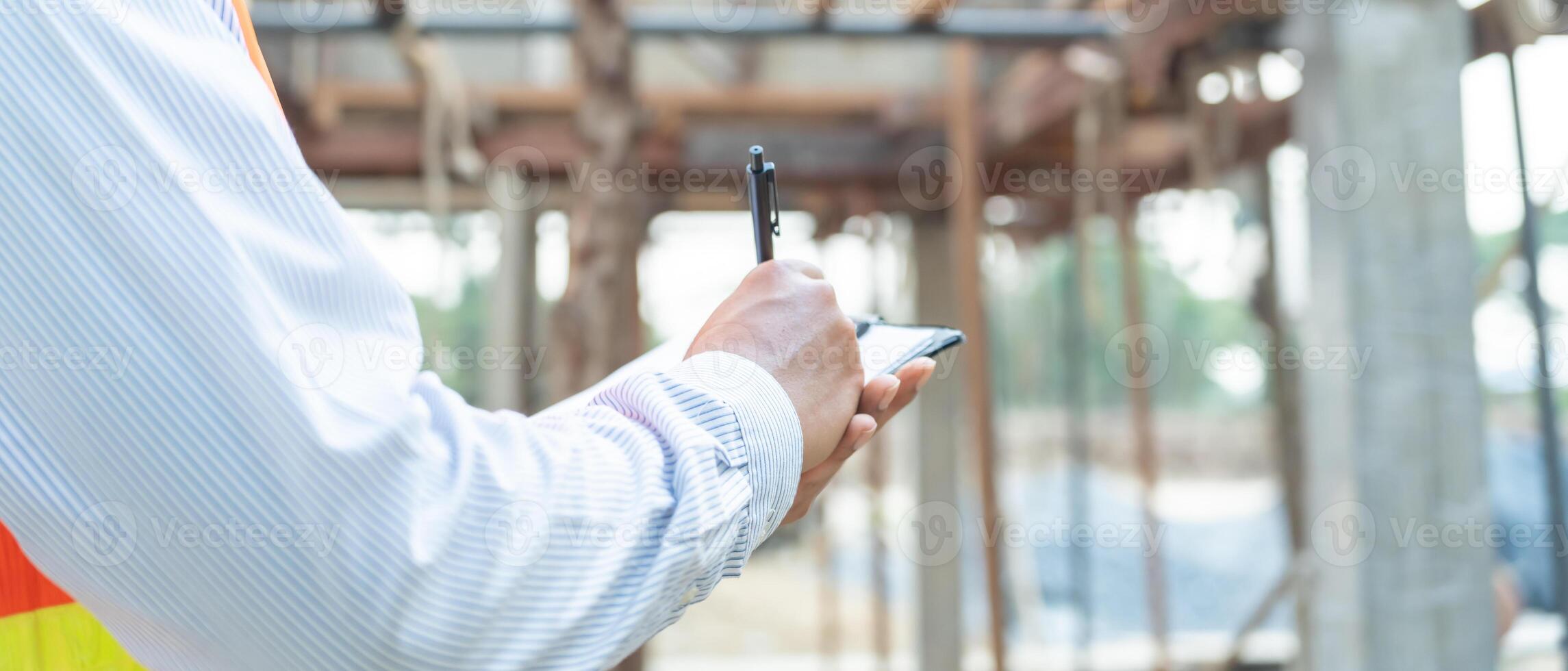 inspector or engineer is inspecting construction and quality assurance new house using a checklist. Engineers or architects or contactor work to build the house before handing it over to the homeowner photo