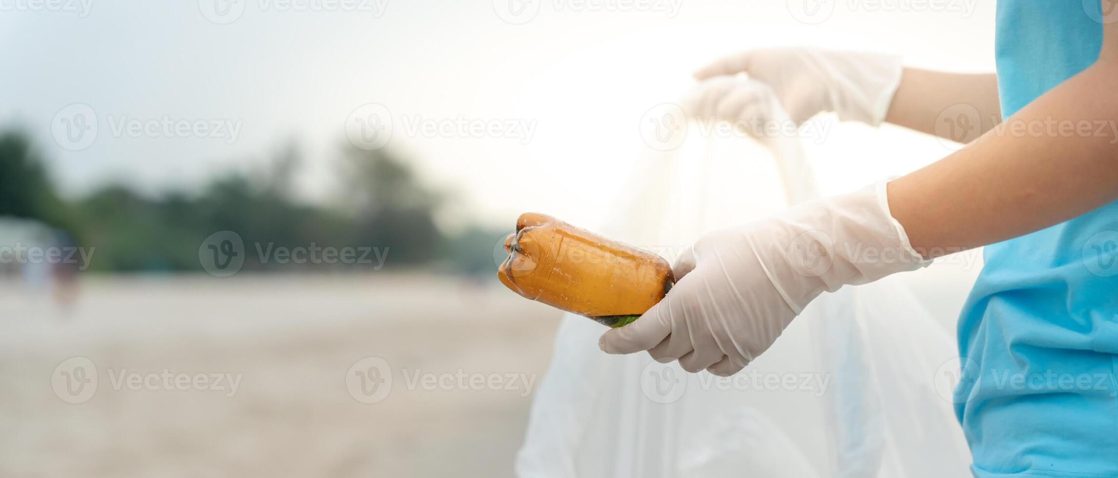 Save water. Volunteer pick up trash garbage at the beach and plastic bottles are difficult decompose prevent harm aquatic life. Earth, Environment, Greening planet, reduce global warming, Save world photo