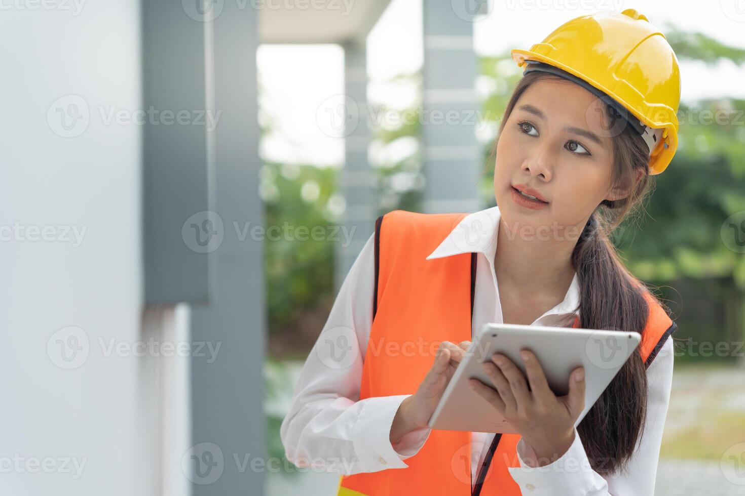 inspector or engineer is inspecting construction and quality assurance new house using a tablet. Engineers or architects or contactor work to build the house before handing it over to the homeowner photo