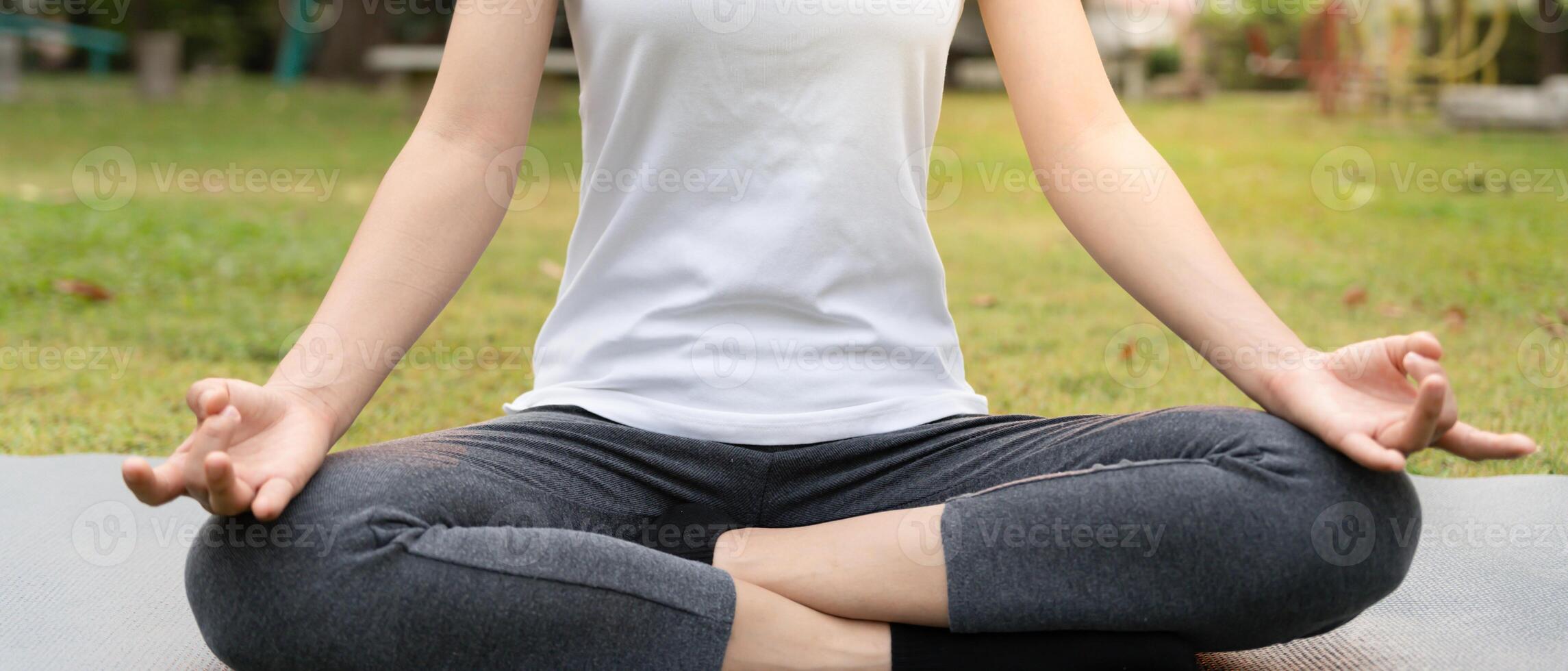 woman practicing meditate on the park. Asian woman doing exercises in morning. balance, recreation, relaxation, calm, good health, happy, relax, healthy lifestyle, reduce stress, peaceful, Attitude. photo