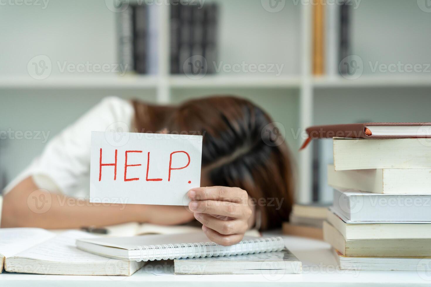 Asian student woman have anxiety because of exams, female hold help in the library. stress, despair, haste, misunderstanding reading, discouraged, expectation, knowledge photo