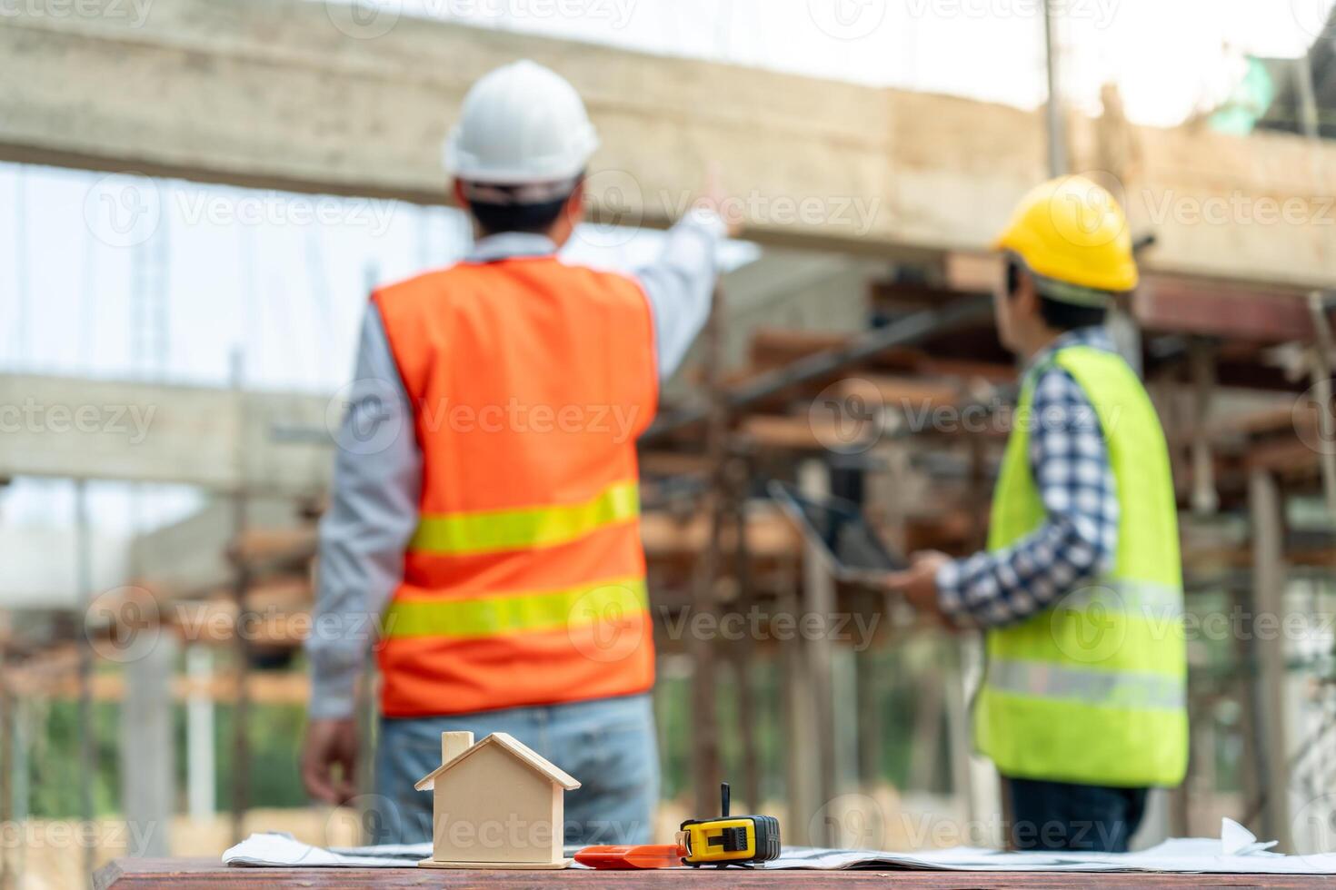 inspector or engineer is inspecting construction and quality assurance new house using computer. Engineers or architects or contactor work to build the house before handing it over to the homeowner photo