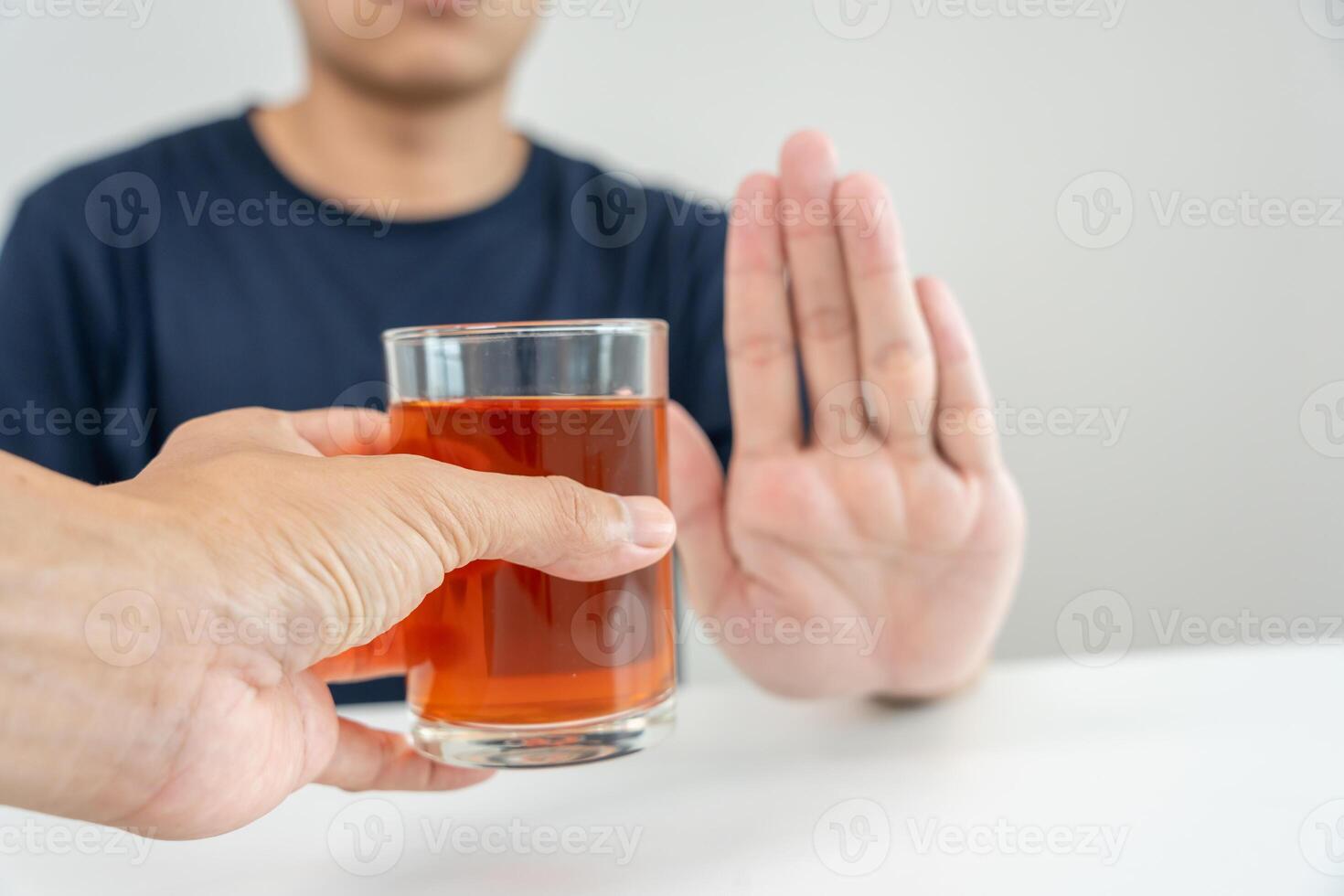 man refuses say no and avoid to drink an alcohol whiskey, stopping hand sign male, alcoholism treatment, alcohol addiction, quit booze, Stop Drinking Alcohol. Refuse Glass liquor, unhealthy, reject photo