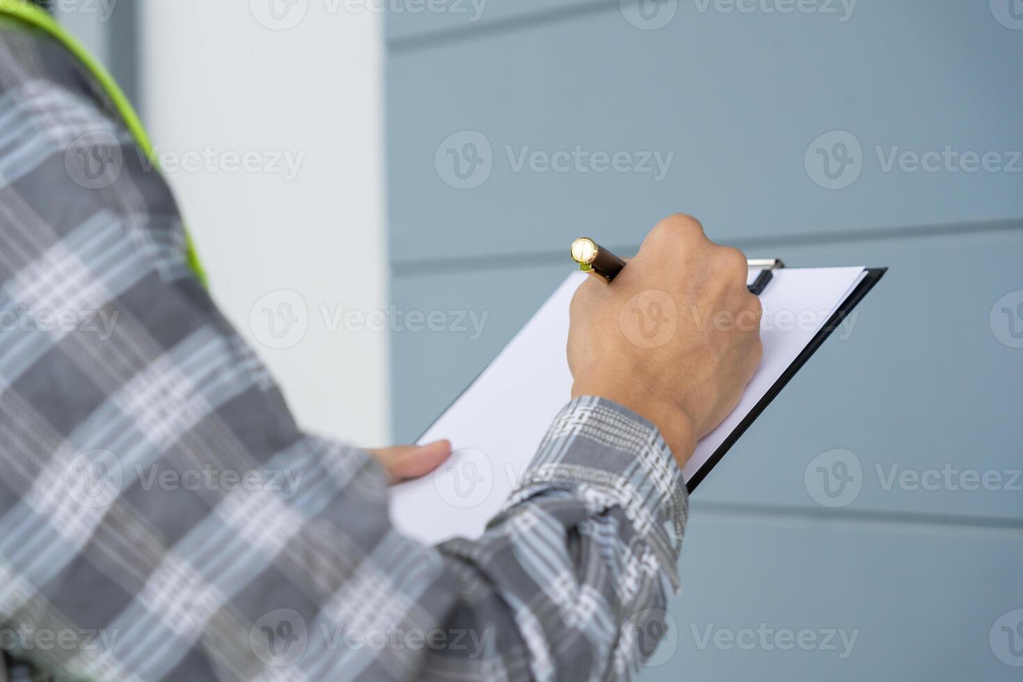 inspector or engineer is inspecting construction and quality assurance new house using a checklist. Engineers or architects or contactor work to build the house before handing it over to the homeowner photo