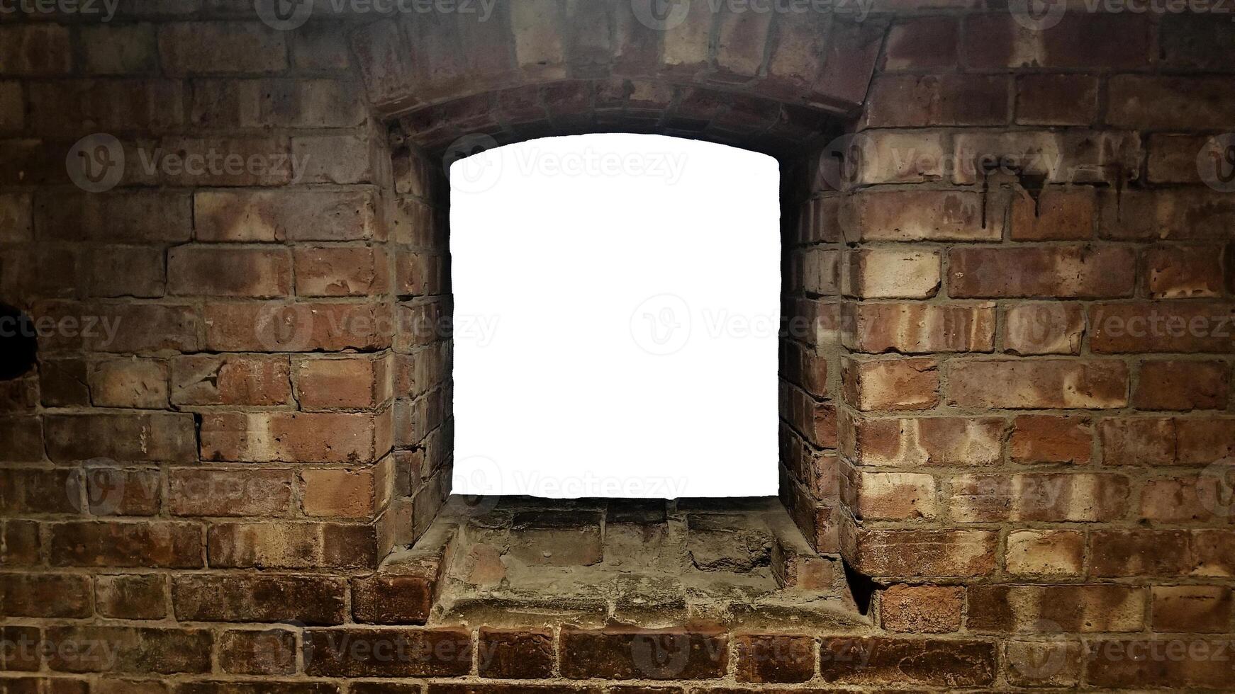 An empty window in a brick wall photo
