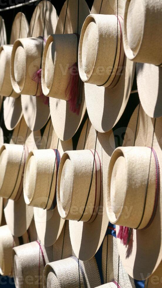 Many hats are hanging on a rack photo