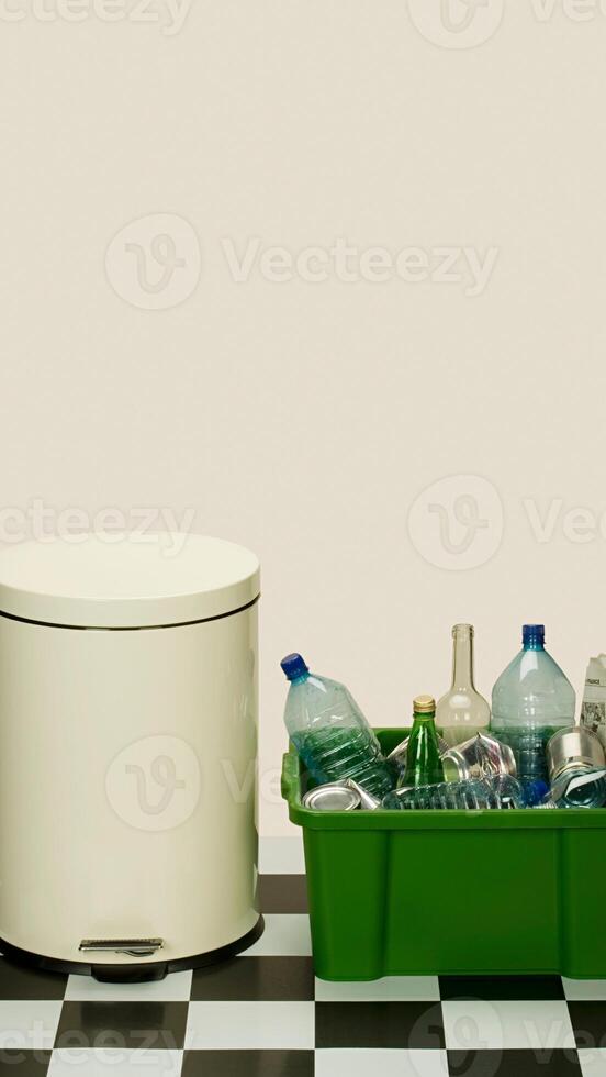 A trash can and a bottle on a checkered floor photo