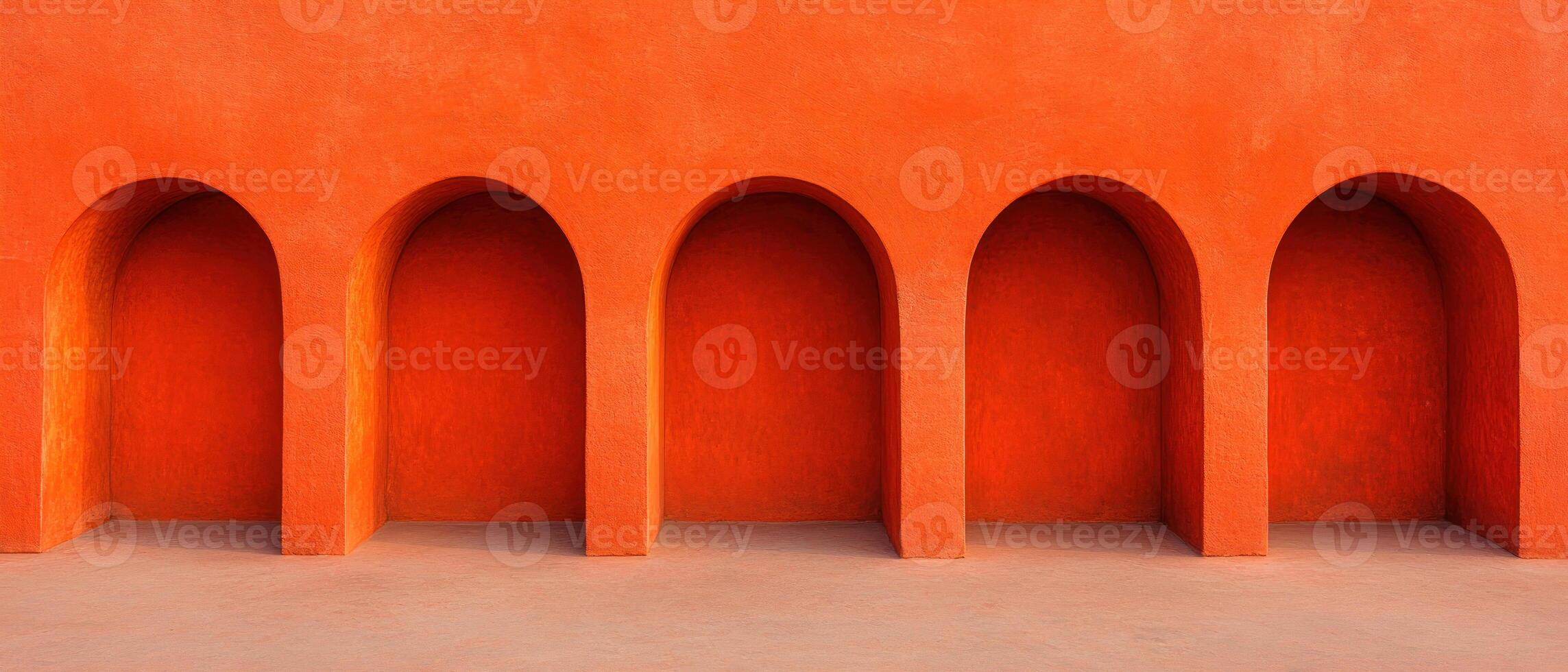 Vibrant orange wall with curved arches creating a striking architectural feature. photo