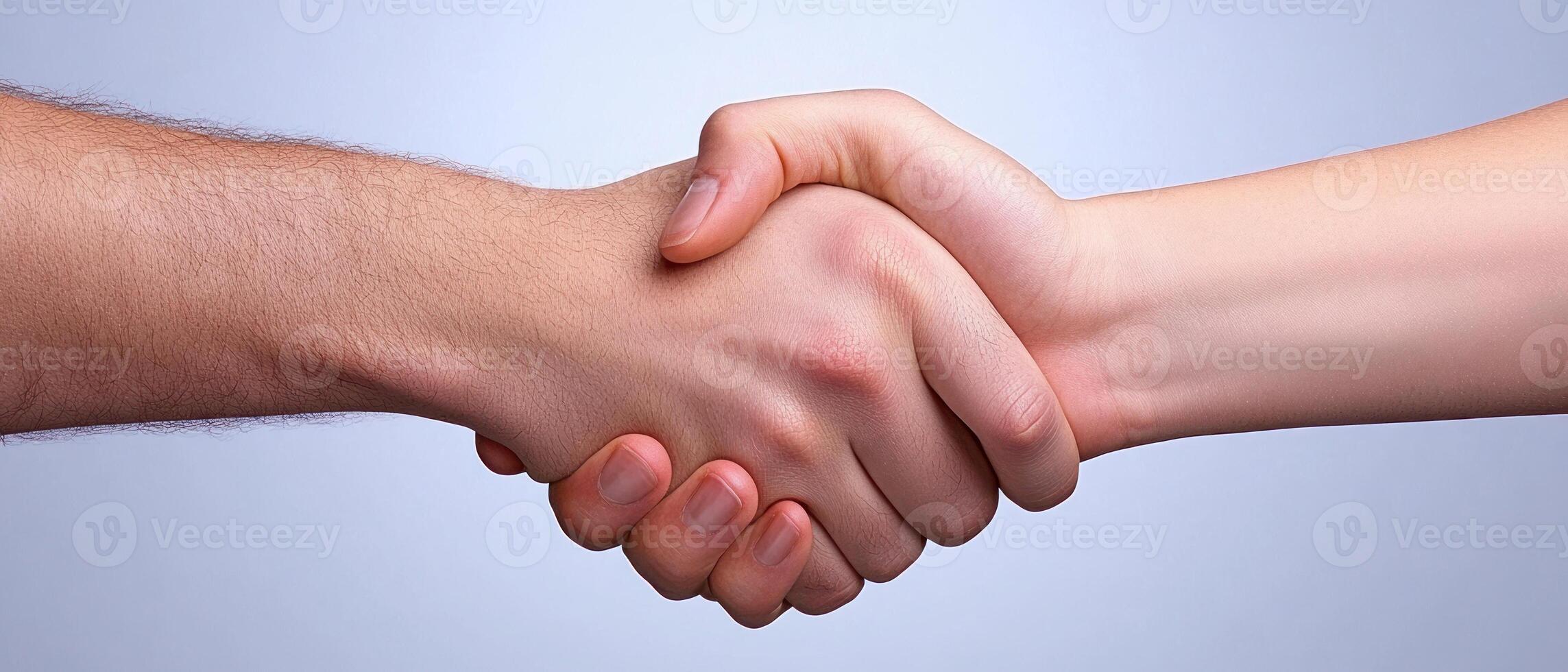 A close-up of two hands shaking, representing partnership and agreement. photo