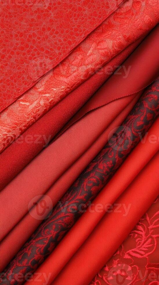 A collection of rich red fabrics showcasing various textures and patterns. photo