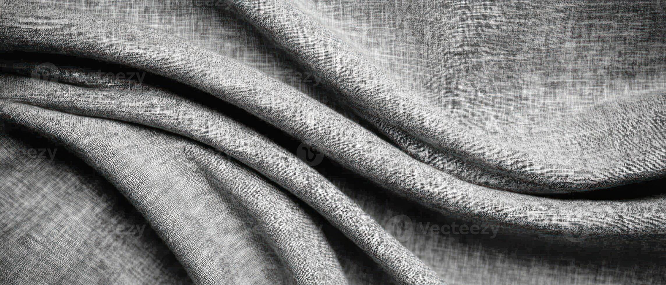 Textured gray fabric draping elegantly in soft waves and folds, showcasing subtle patterns. photo