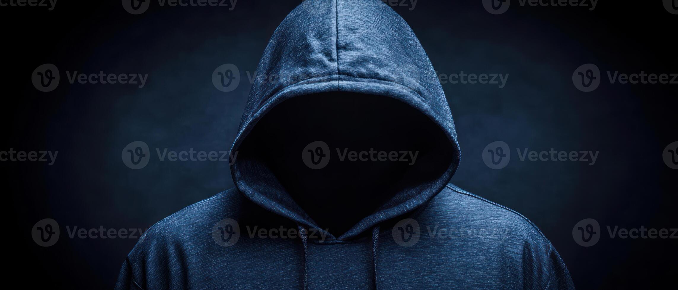 A mysterious figure in a hoodie, face hidden in shadows, symbolizing anonymity. photo