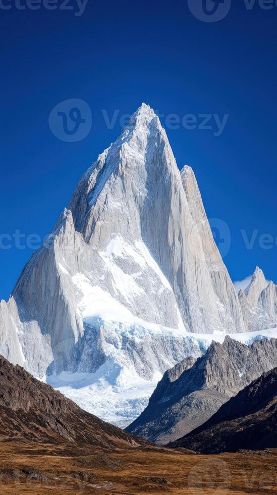 Majestic mountain peak against a clear blue sky showcasing nature's beauty. photo