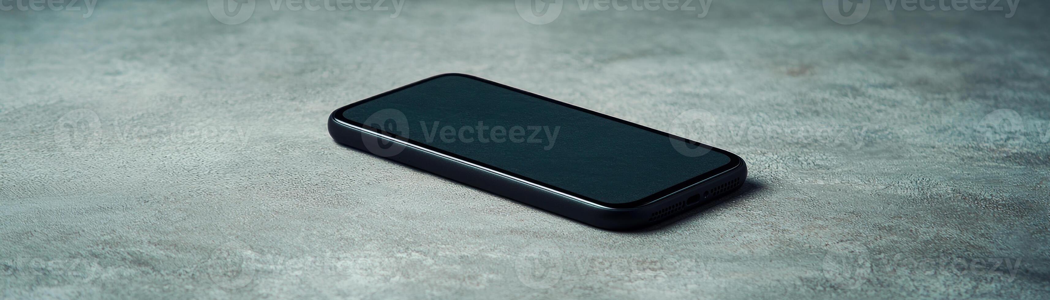 A sleek smartphone lying flat on a textured surface, showcasing modern design and technology. photo