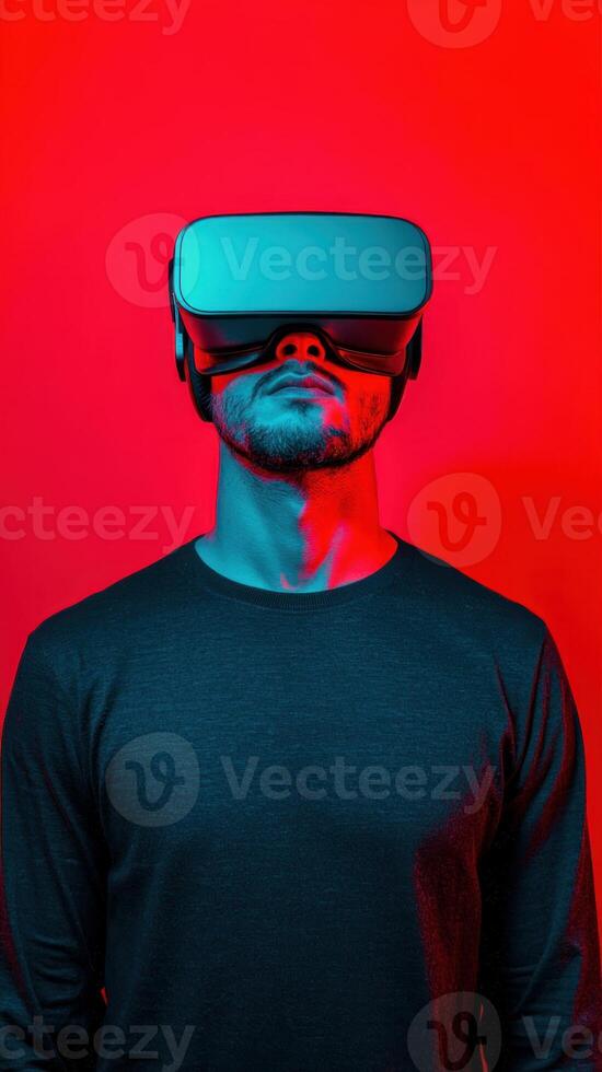 A man wearing virtual reality goggles in a vibrant red and blue setting. photo
