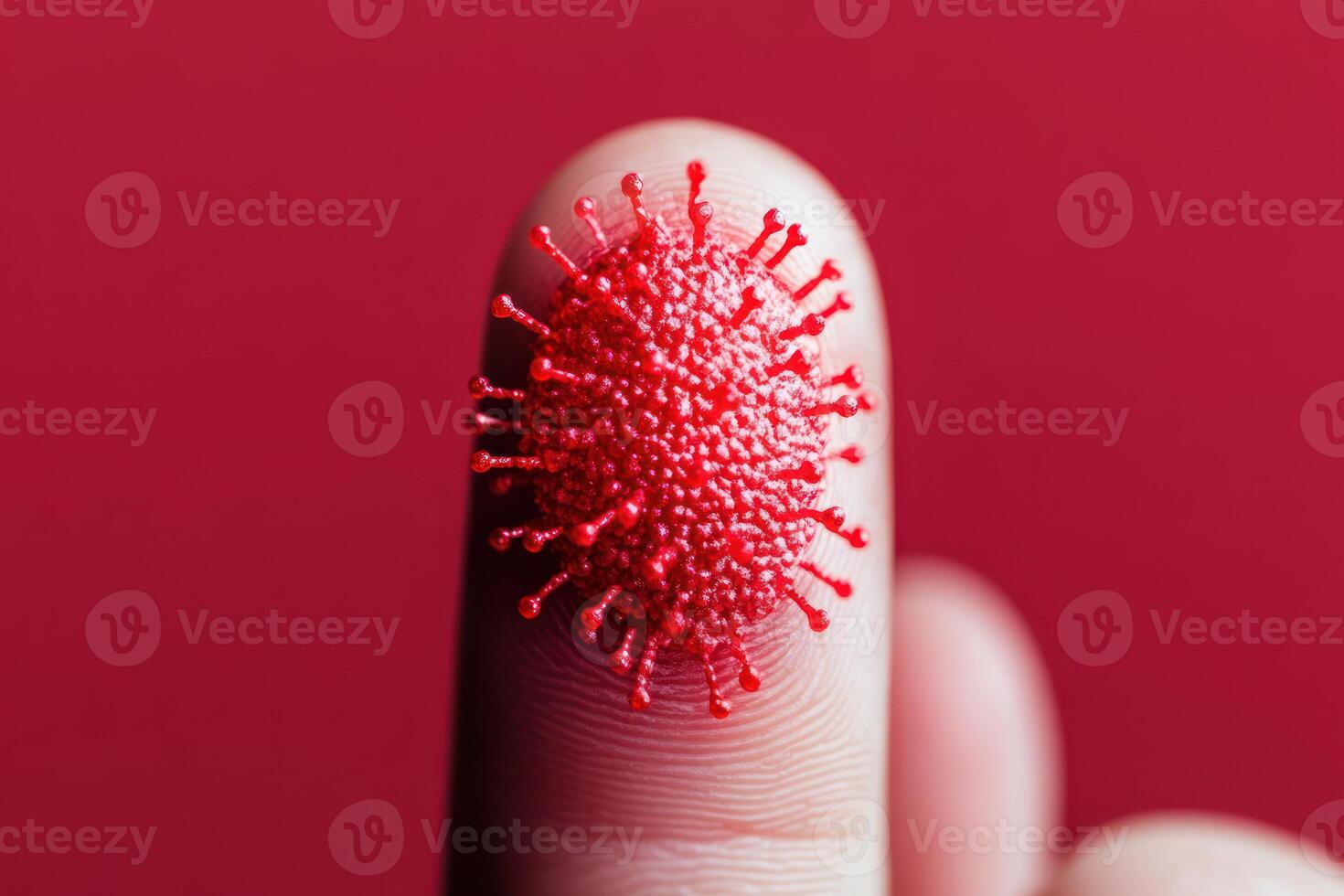 Close-up of a finger with a red virus model, depicting infection. photo