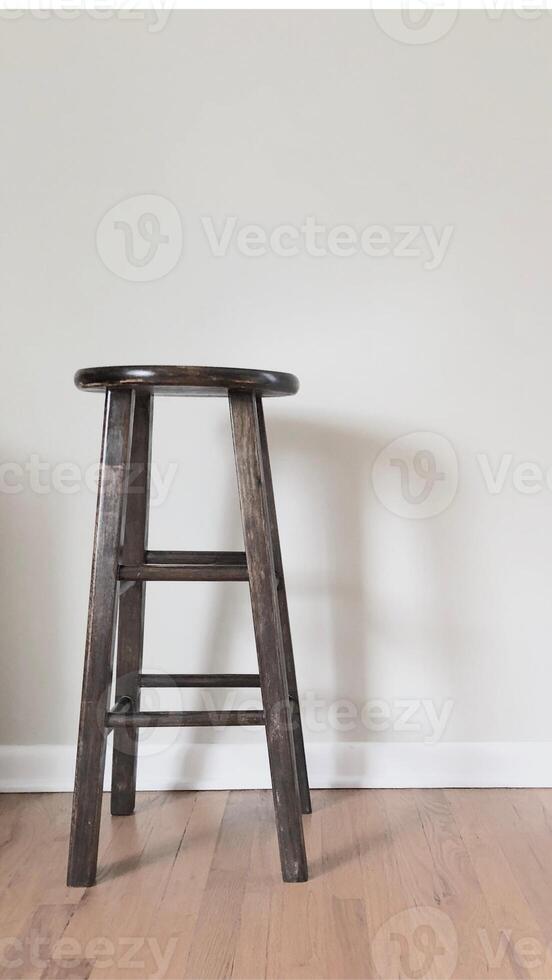 A stool in a room with hardwood floors photo