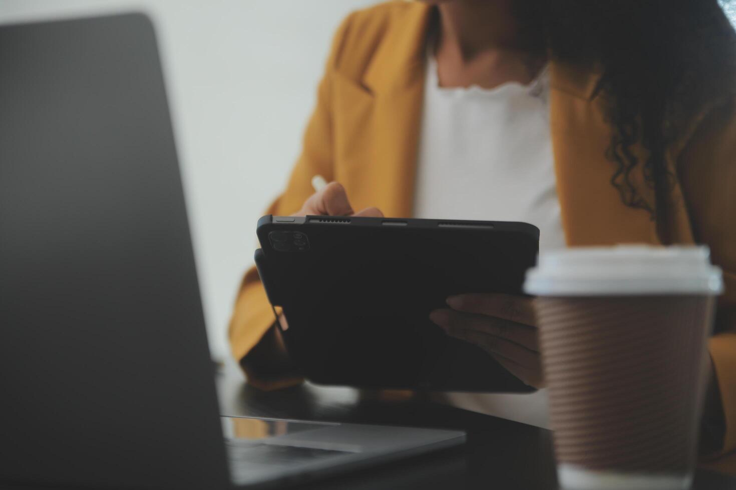 Close up Business woman using calculator and laptop for do math finance on wooden desk, tax, accounting, statistics and analytical research concept photo