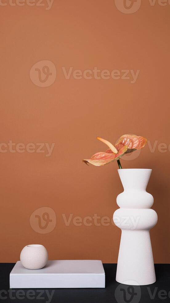 A white vase with a flower on it photo