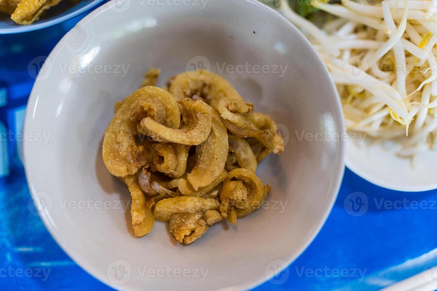 Pork rinds or deep fried pork skin in white bowl photo