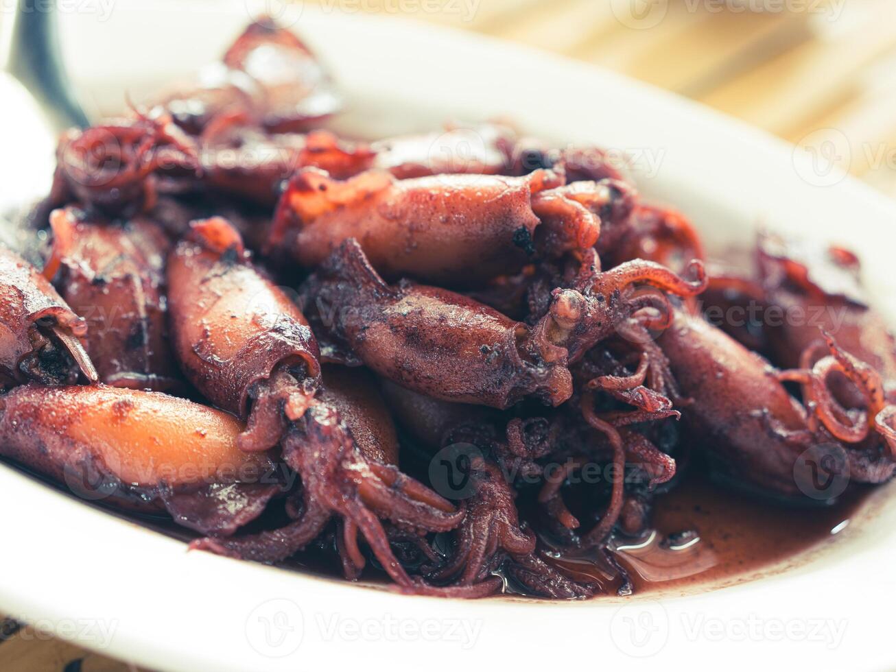 Sauteed black squid is processed squid that is cooked until the squid ink is released. The resulting taste is very distinctive. photo