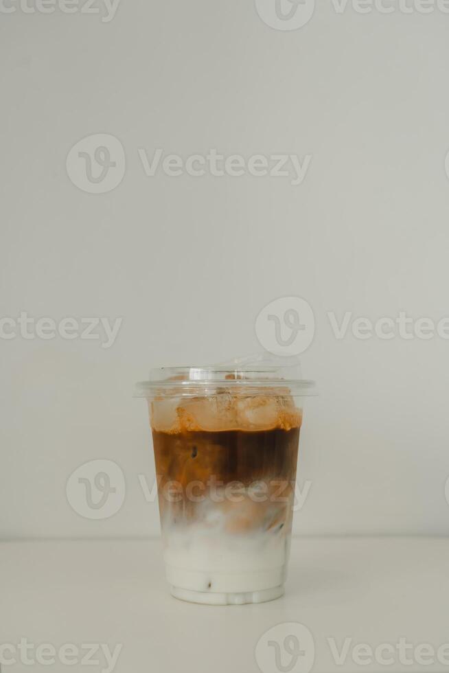 Cold iced latte coffee, showing separate in a layer the bottom as milk top by coffee shot in glass photo
