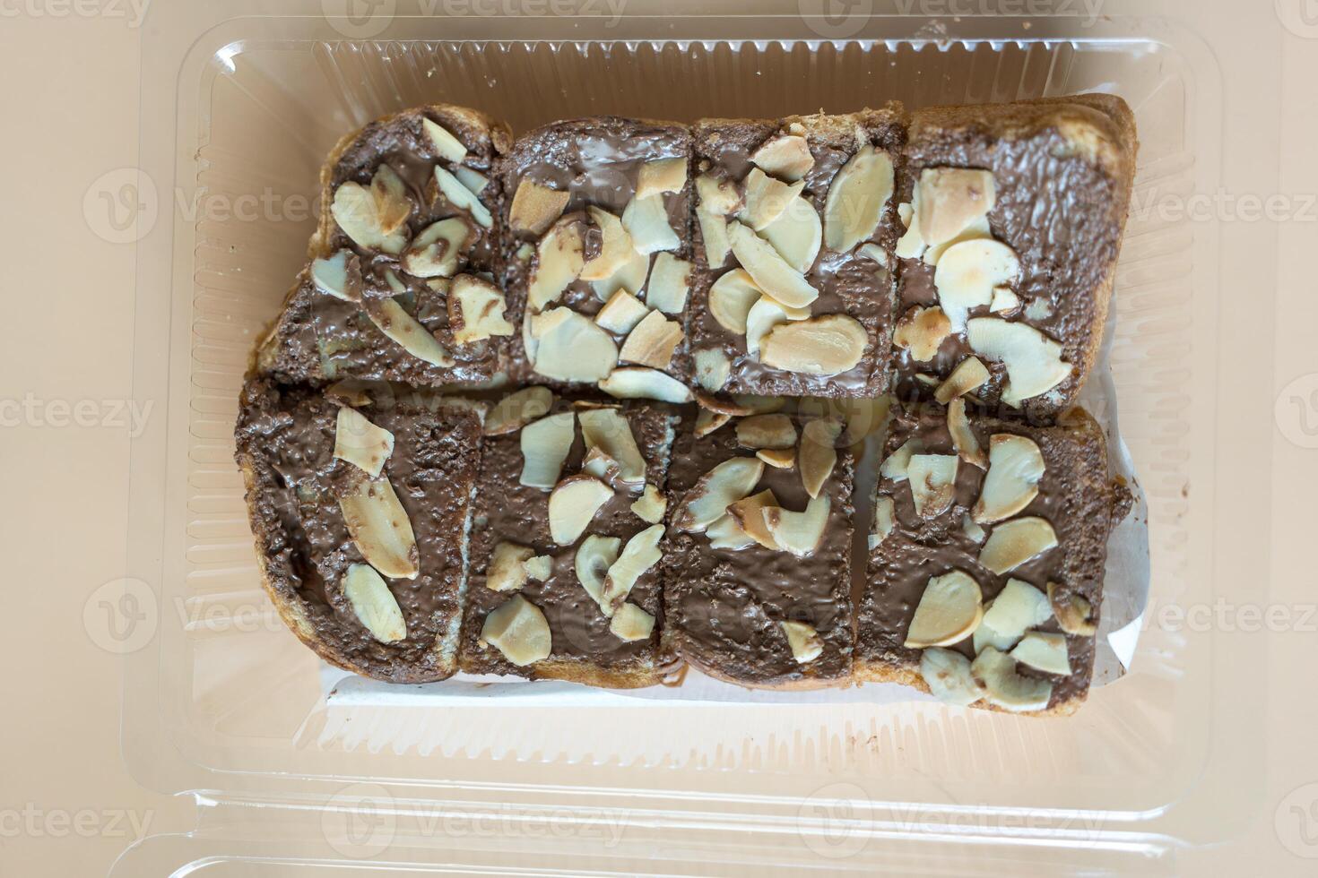 Slices of toast bread with chocolate cream and nuts photo