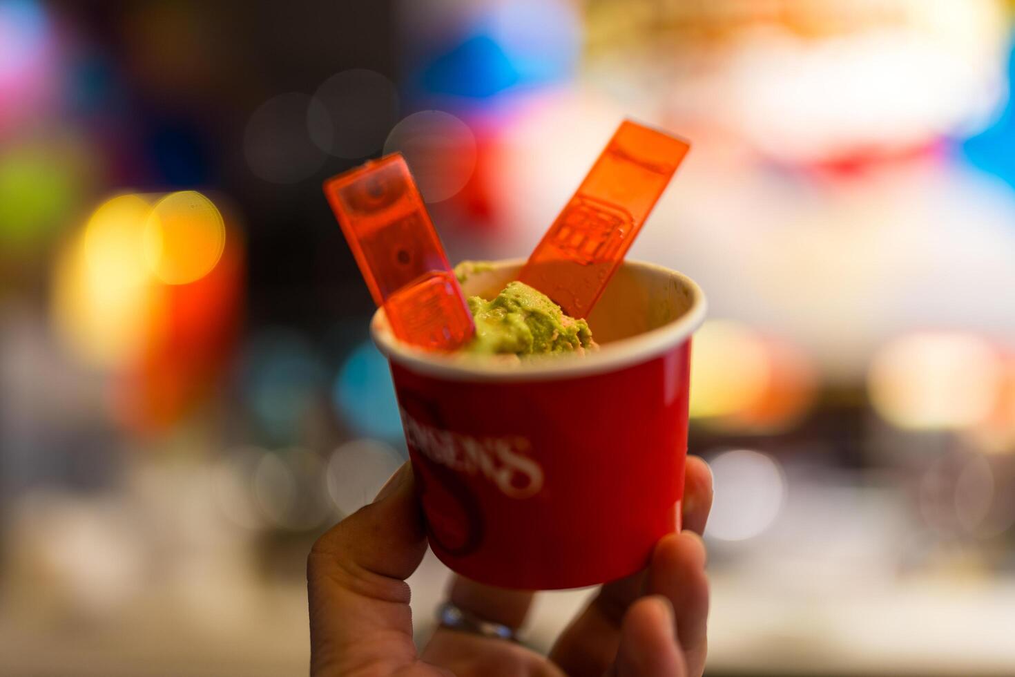 Bangkok, Thailand - November 23, 2024 Holding a paper cup of iceem scoop from Swensen ice cream shop. photo