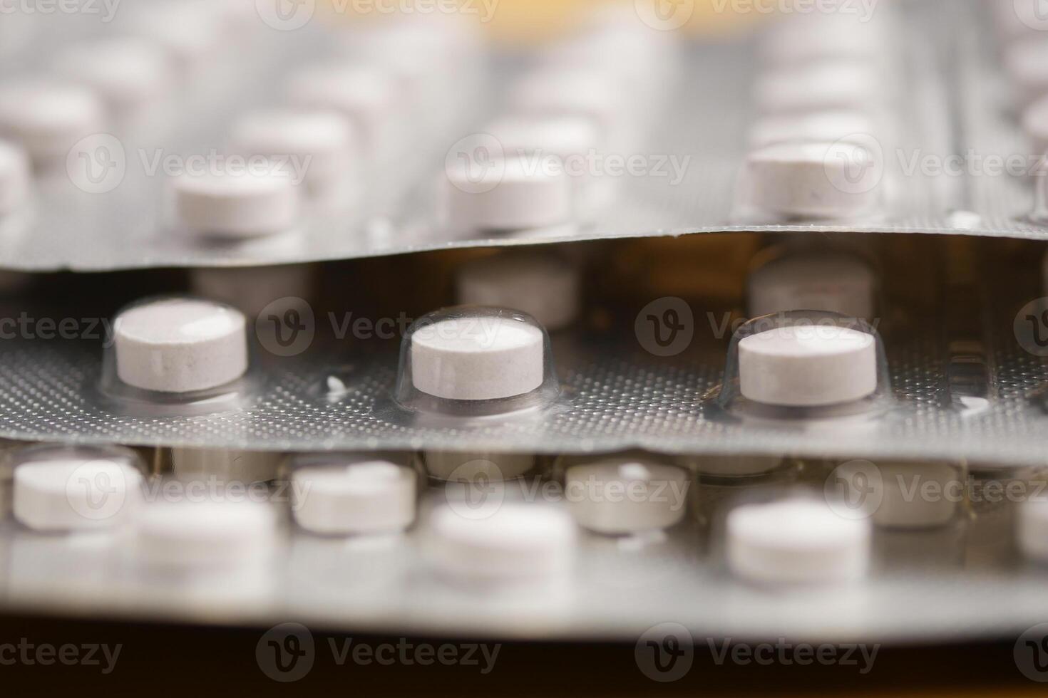 A detailed view of white pills neatly arranged in their blister packs photo
