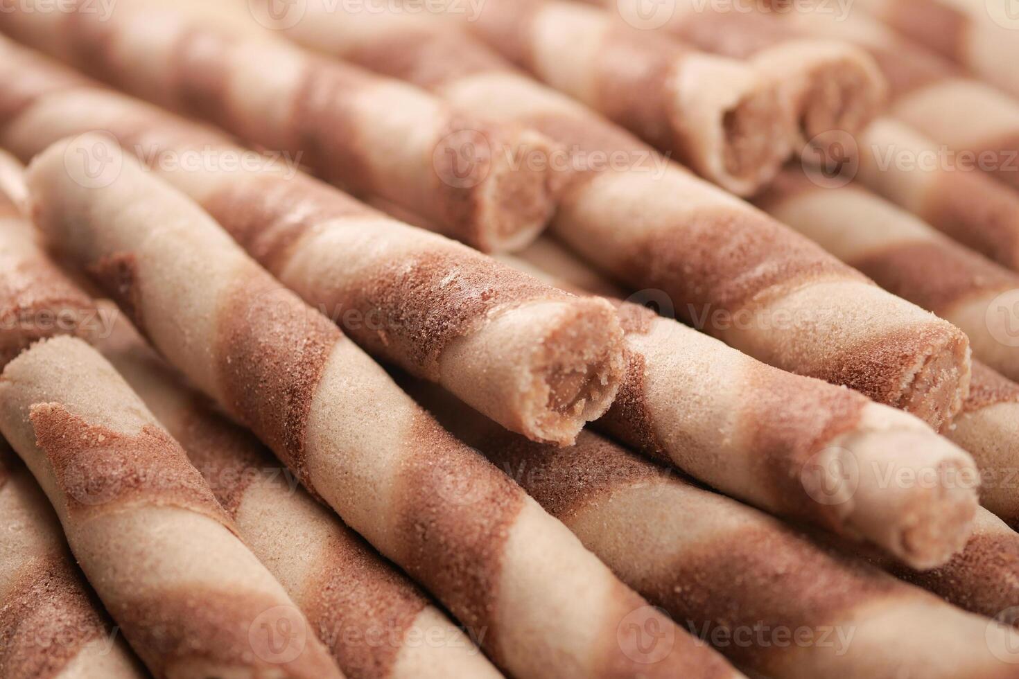 These Delicious Swirled Wafer Rolls are beautifully situated on a Wooden Surface photo