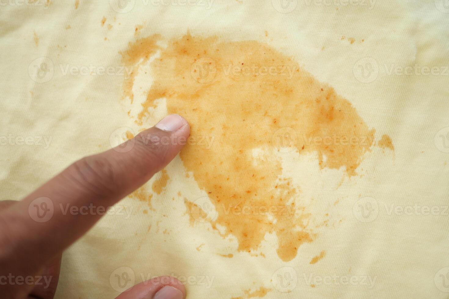 Stained Fabric CloseUp Detailed View of Patterned Material Featuring an Orange Mark photo