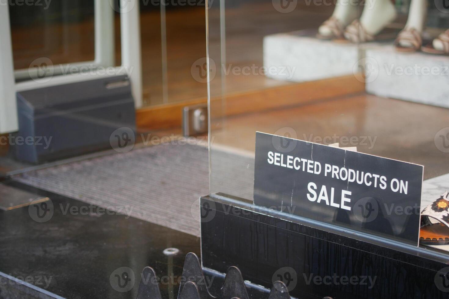 The store entrance signage clearly indicates that there is a sale on selected products available photo
